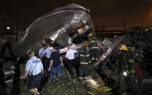 Emergency personnel work the scene of a train wreck, Tuesday, May 12, 2015, in Philadelphia. An Amtrak train headed to New York City derailed and crashed in Philadelphia. (AP Photo/Joseph Kaczmarek)