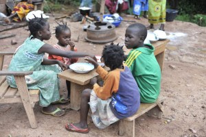 23 May 2012, Mbaiki, Central African Republic - Children eating cassava.FAO Project: OSRO/RAF/912/EC - Regional Cassava Initiative in support of vulnerable smallholders in eastern and central Africa. Enhanced utilization of technologies and innovations for sustainable productivity of cassava in eastern and central Africa.