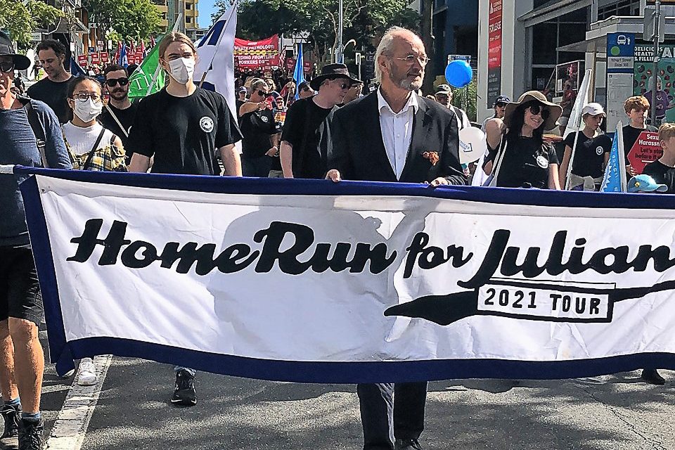 Julian Assange’s father marches for his son